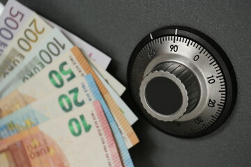 safe code lock on a gray background with money of the European Union, banking system