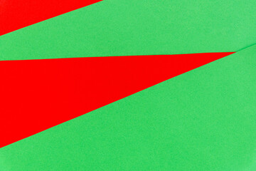 Abstract bright red on green paper background.