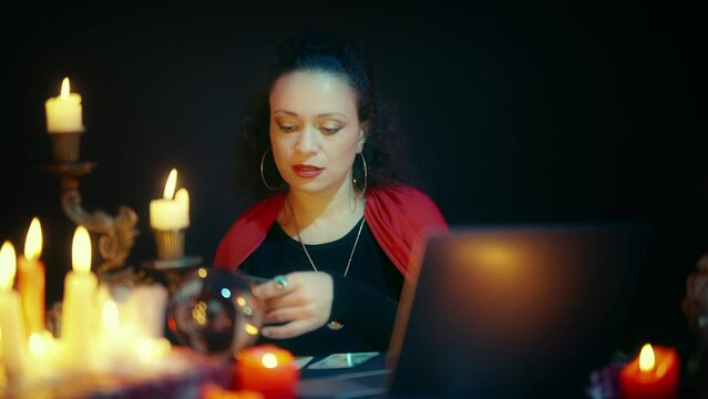 Female fortune-teller having online webinar, teaching how to interpret tarot