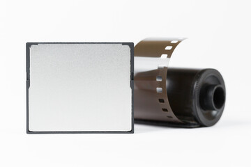 shot of the digital flash memory card (Shallow DOF) and old-style 35 mm film on a white background
