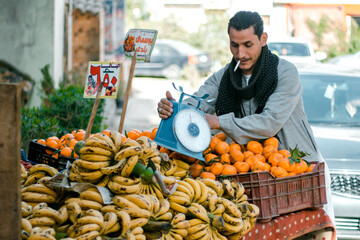 Fruit seller on the street of an Arab city.