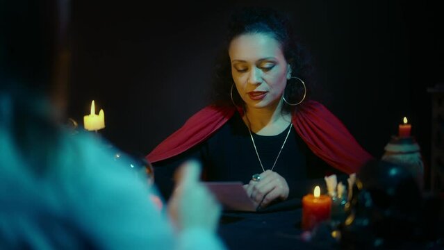 Female psychic predicting future or connecting with soul using photo, witchcraft
