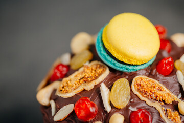 Easter cake, panettone in packaging for sale. Traditional Easter cake cut with raisins, Easter is ready for the holiday on a dark background with slices of dry orange and macaroon, boiled chicken eggs