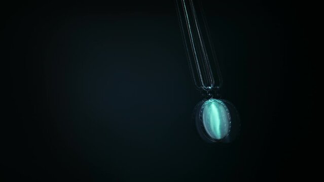 Pendant swaying on chain, putting person into a state of trance, hypnosis, magic