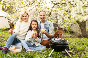 smiling parent grilling meat with daughter on camping