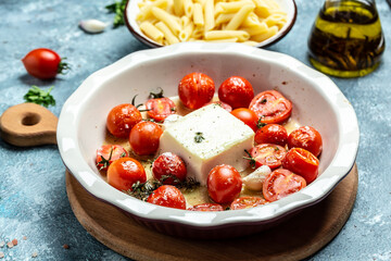 cooking recipe Fetapasta with cherry tomatoes, feta cheese, garlic and thyme on white plate. banner, menu, recipe place for text, top view