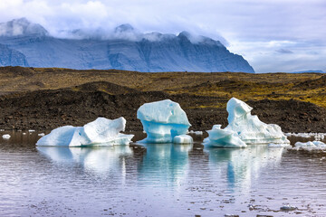 Fjallsarlon Glacier Lagoon, Iceland. Blue icebergs float and are reflected in the water. Part of the Vatnajokull National Park