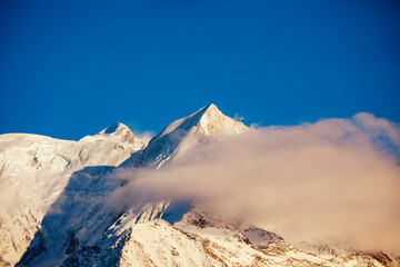 Aiguille de Bionnassay peak of Mont Blanc in sunset clouds © Sergey Novikov