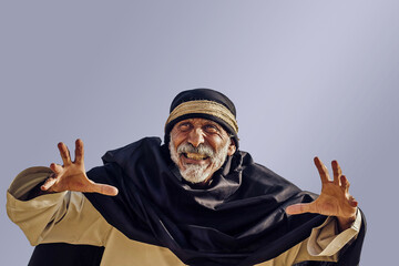 An old dangerous Arab sorcerer in national clothes.