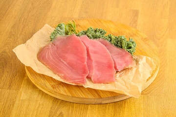 Raw salted tuna slice over board