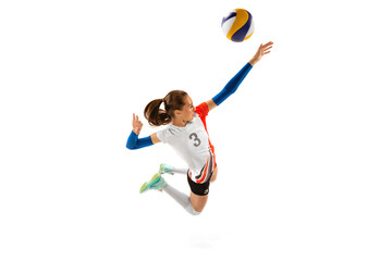 Aerial view of professional volleyball player in sports uniform in motion with ball isolated on...