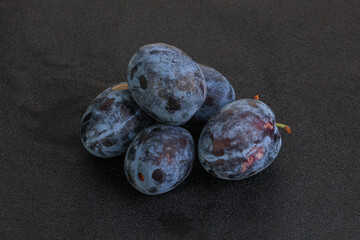 Ripe plum heap over background