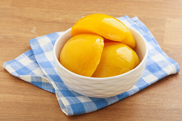 Sweet canned peaches with syrope