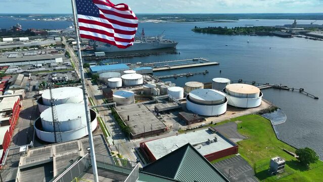 Fuel crude oil storage at port in USA. American flag. Energy crisis in America theme. Fuel gasoline prices.