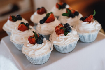 cupcakes with cream and berries