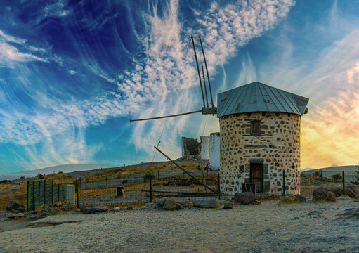 Symbol of the city of Bodrum Turkey ancient windmill on a hill. Sky with clouds.