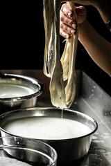Cheesemaker, showing freshly made mozzarella. The homemade cheese maker produces caciocavallo. Pasta filata, Traditional Italian mozzarella