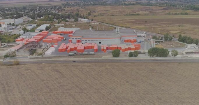 Exterior of new factory. dern factory in gray-orange colors from the air. Flight near modern factory