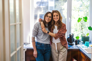 Portrait of affectionate lesbian couple embracing at home