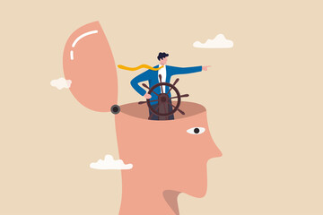 Self control or leadership thinking for business decision or guidance to the right direction, motivation, mindset or consciousness concept, businessman leader control steering wheel helm on his head.