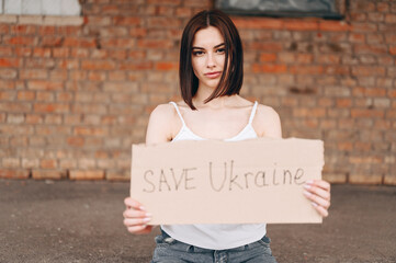 Out of Focus Horizontal Woman Portrait with Poster Save Ukraine in Out of Focus.