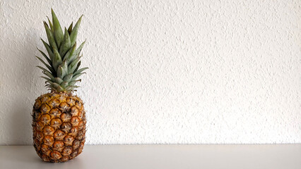 delicious pineapple stands on a light background