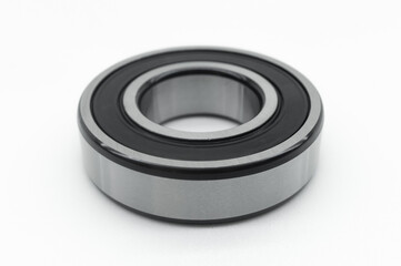 Closed type bearing for modern equipment and machines on a white background. Italian ball bearing with protective covers. Selective focus
