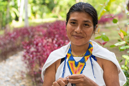 Stock photo of a portrait of a Colombian woman in traditional clothing. Beautiful shot of a young indigenous woman from the Sierra Nevada de Santa Marta, smiling looking at the camera.