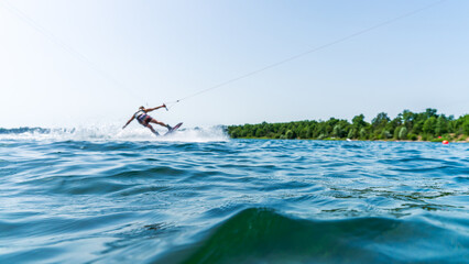 Water surface with a blurred athlete wakeboarding in the background