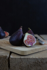 Two and a half fresh figs on the rustic style wooden table