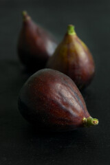 Three fresh figs on the black table