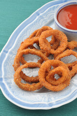 Deep fried onion rings with tomato ketchup, a tea time snack