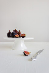 Fresh figs on the white stand with gray background