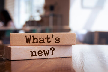 Wooden blocks with words 'What's new?'. Business concept