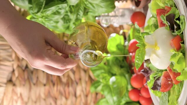 Salad with Tomatoes, Burrata, basil,olive oil. middle name Burratina. Traditional cheese from the south of Italy in the Puglia region. Round soft cheese inside liquid stracciatella texture.4k.vertical