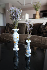 Bouquets of aromatic dried lavender or lavandin flowers in beautiful vases