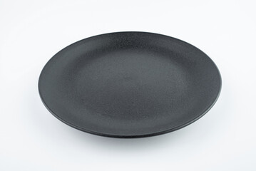 A black frosted plate dish on a white background