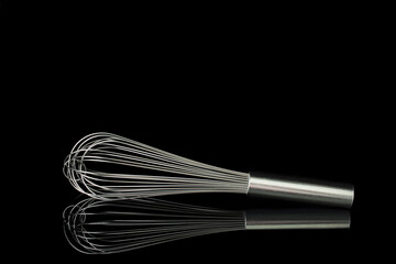 A silver stainless steel whisk in black