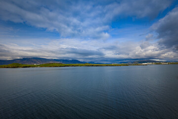 A view of the harbor close to Reykjavik, Iceland with small strip of land hosting one of the city neighborhoods.