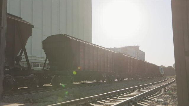 Freight train rides through the factory. Railway waggons move around the plant. Freight train in a factory