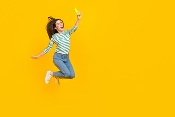 Fototapeta na wymiar Full size photo of casual wear girl take selfie make photo for her blog new post isolated on yellow color background