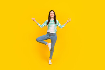 Fototapeta na wymiar Full body image of beautiful charming woman practice mindfulness doing yoga isolated on yellow color background