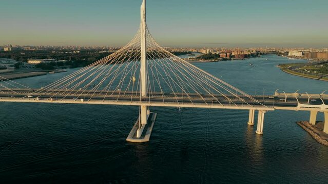 Sunset, flight over the cable-stayed bridge of the motorway, over the Neva River in St. Petersburg