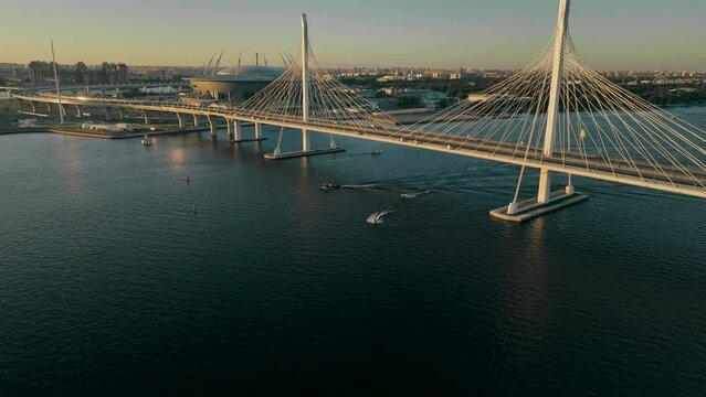 Sunset, flight over the cable-stayed bridge of the motorway, over the Neva River in St. Petersburg