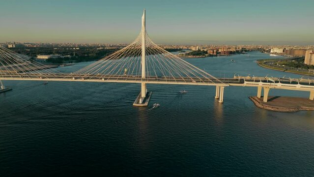 Sunset, flight over the cable-stayed bridge of the motorway, over the Neva River in St. Petersburg