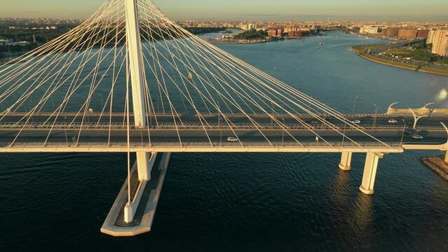 Sunset, flight over the cable-stayed bridge of the motorway, over the Neva River in St. Petersburg