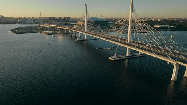 Sunset, flight over the cable-stayed bridge of the motorway, over the Neva River in St. Petersburg