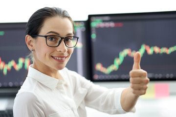 Happy woman trader showing thumb up gesture