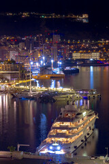 Night view of a luxury yacht parked in the port of Hercule, Principality of Monaco. Luxurious dear...