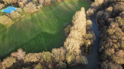 Aerial view looking down onto trees and countryside with houses and buildings in a rural setting. Taken in Lancashire England. 